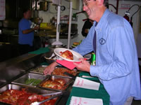 Tim serving up some chicken parmesan.